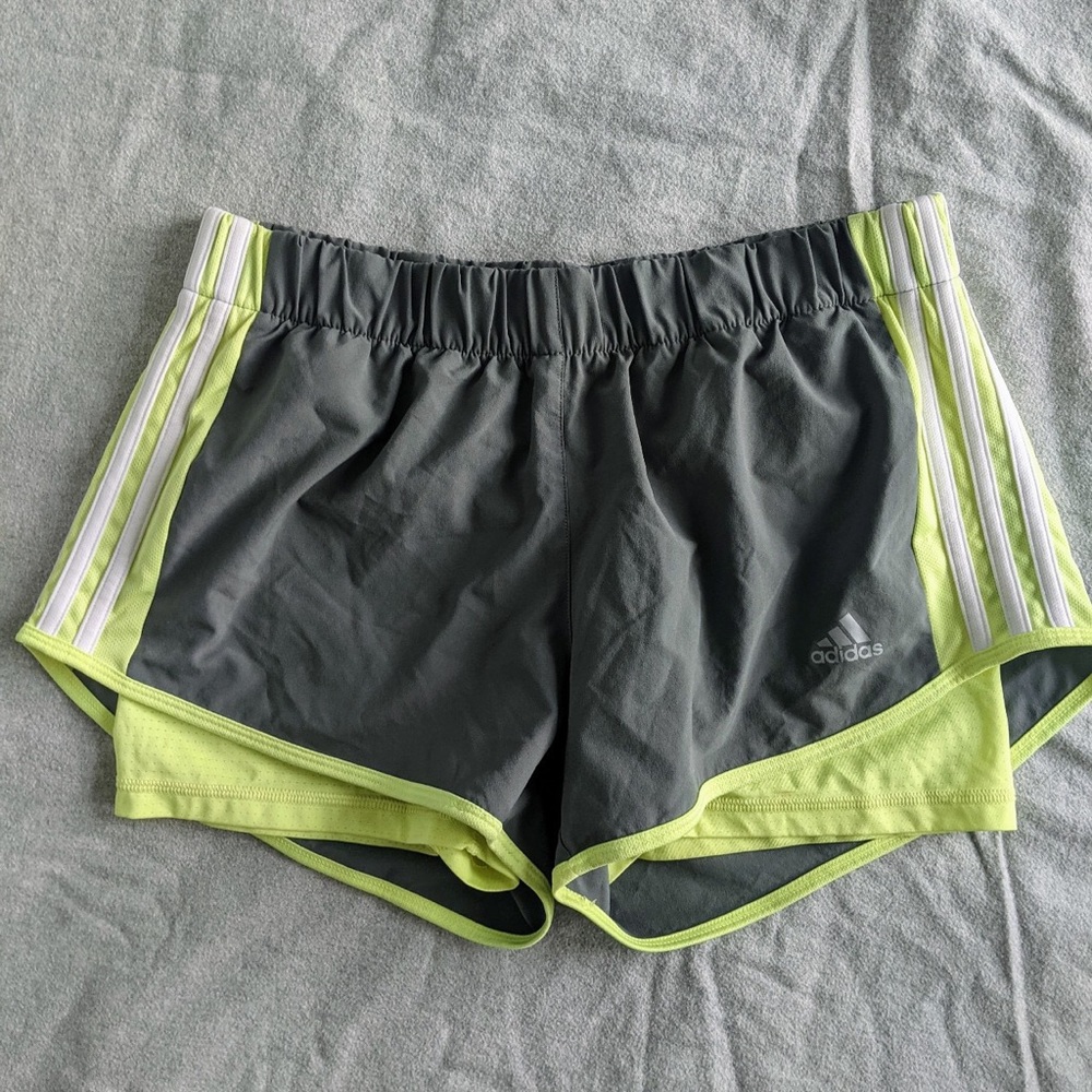 Grey and neon yellow Adidas athletic shorts.